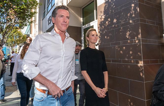 Governor-elect Gavin Newsom and his wife, Jennifer Siebel Newsom, walked to the dining room at St. Anthony's in San Francisco where they helped serve meals shortly after the November election. Photo: Jane Philomen Cleland