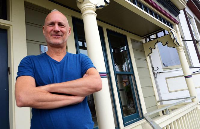 Misterb&b host Alan Lessik stands on the porch of his Victorian cottage in Bernal Heights. Photo: Rick Gerharter