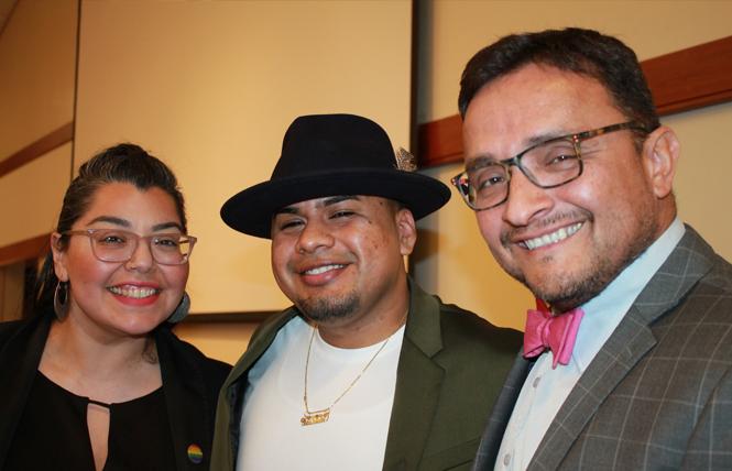 Maribel Martinez, left, director of Santa Clara County's Office of LGBTQ Affairs, joined undocumented queer poet Yosimar Reyes and David Campos, deputy county executive, at the Beacon of Light Awards ceremony in Campbell January 25. Photo: Heather Cassell