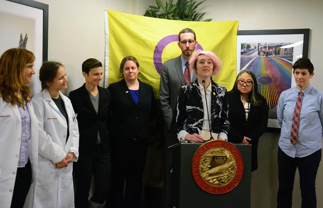 Hans Lindahl, director of communications and outreach for InterACT Advocates for Intersex Youth, speaks in support of state Senator Scott Wiener's (standing behind Lindahl) legislation to prohibit medically unnecessary genital surgery on intersex infants at a Monday news conference. Photo: Rick Gerharter