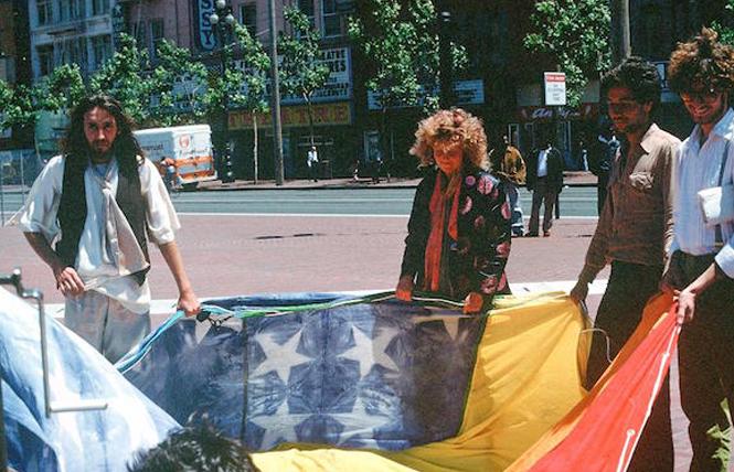 Gilbert Baker, left, and Lynn Segerblom held an original rainbow flag with other volunteers in 1978. Photo: James McNamara, courtesy Paul Langlotz