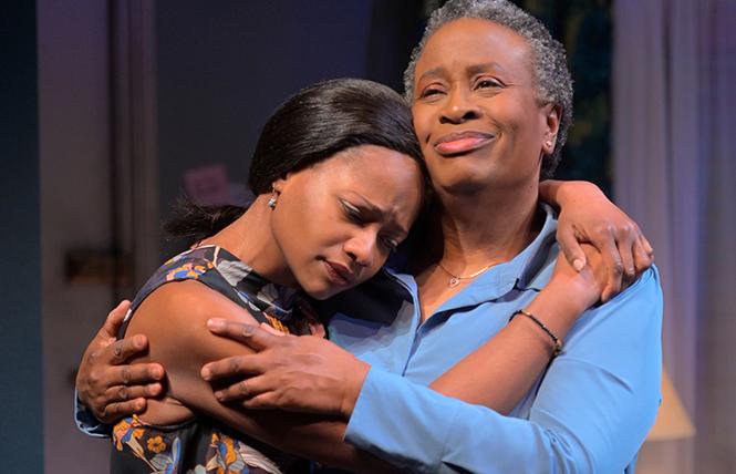 Abasiama (Kimberly Scott, right) holds Iniabasi (Eunice Woods) in Mfoniso Udofia's "Her Portmanteau," now playing A.C.T.'s Strand Theater. Photo: Kevin Berne