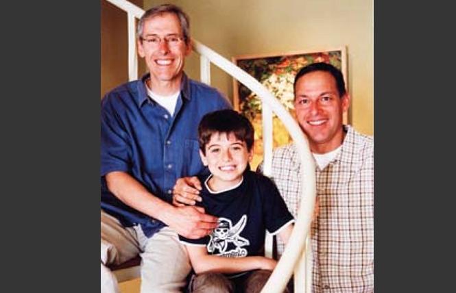 George Randall-Saldivar, center, shown with his dads, Mark Randall, left, and Chris Saldivar in 2006, was killed last month in San Francisco. Police have arrested two people in the case. Photo: Rick Gerharter