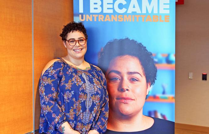 Spokesmodel Rikki Vick, born with HIV and living with undetectable virus, stands in front of a poster of herself that is part of Santa Clara County's new U=U campaign. Photo: Jo-Lynn Otto