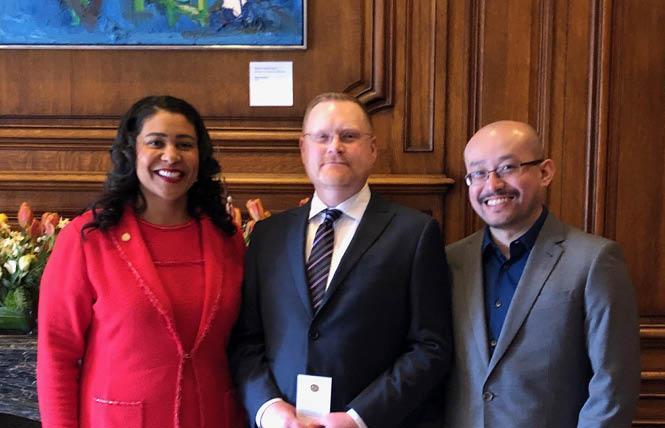 Mayor London Breed, left, swore in Reese Aaron Isbell March 29 to a seat on the San Francisco Rent Board. With them is Isbell's husband, Sheng "Bruce" Yang. Photo: Courtesy SF Mayor's Office  