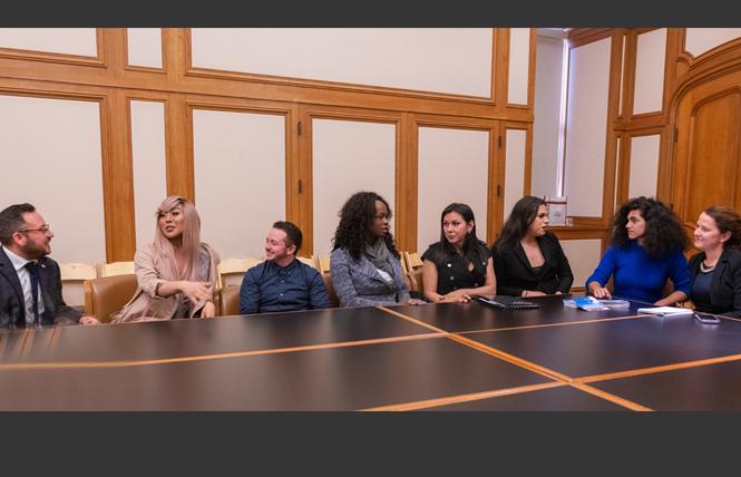 Maceo Persson, left, discusses the new Our Trans Home — San Francisco campaign with Melanie Ampon, JM Jaffe, Akira Jackson, Jessy D'Santos, Rexy Amaral Tapia, Shane Zaldivar, and Clair Farley during an April 4 debriefing in the mayor's conference room at City Hall. Photo: Jane Philomen Cleland