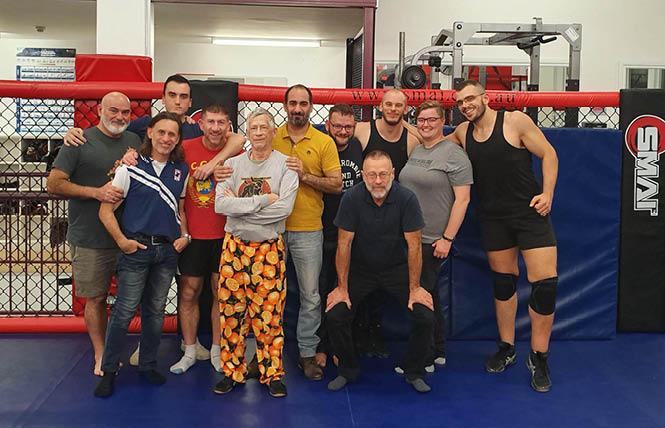 Wrestlers in Sydney, including Roger Brigham, fifth from left, gather at a clinic. Photo: Courtesy Andrew Farrell