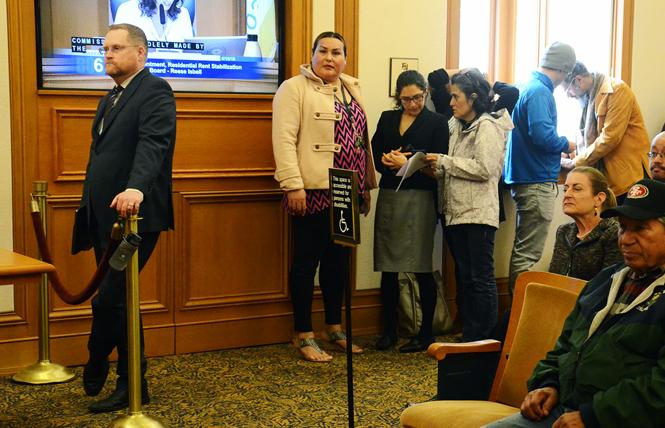 Reese Aaron Isbell, left, stands to the side during a meeting of the Board of Supervisors rules committee Monday as other people wait to speak. Photo: Rick Gerharter