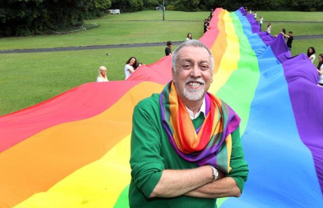 Gilbert Baker stands in front of one his rainbow flags. Photo: Mark Maxwell/courtesy GLBT Historical Society