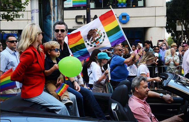 Gavin Newsom, then California's lieutenant governor, and his wife, Jennifer Siebel Newsom, took part in the 2018 San Francisco Pride parade. Photo: Rick Gerharter