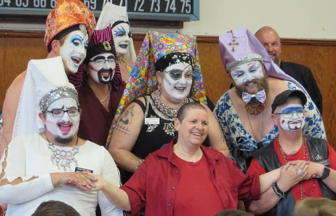 Members of the Russian River Sisters of Perpetual Indulgence appeared on stage just before the start of the June 8 Let's Play Doctor bingo in Guerneville. In back, from left, Sister Frances A. Sissy, Sister Scarlet Billows, Sister Sparkle Plenty, and Aspirant Sharon da Goods. In middle row, from left, Sister Sorenda 'da Booty and Sister Bette Sheezahee. In front, from left, Novice Eliza Mench, a visiting Buddhist nun who declined to provide their name, and Guard Ian Avirtue. Photo: Charlie Wagner