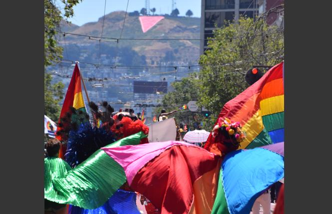 The pink triangle can be seen on Twin Peaks as a contingent marches in the San Francisco Pride parade. Photo: Patrick Carney