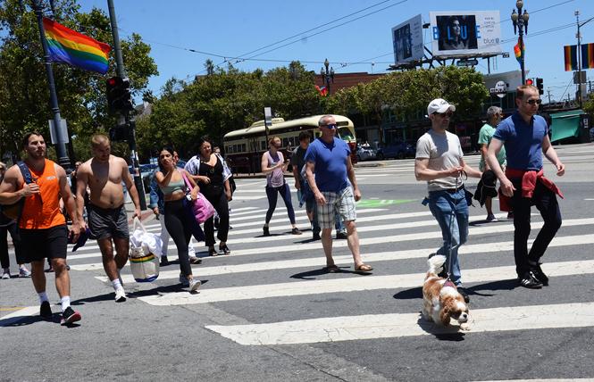 Pedestrians walk on Market Street at Noe, which will be part of the Castro LGBTQ Cultural District. Photo: Rick Gerharter