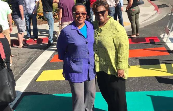 Nancy Hinds, left, and her spouse, Brendalynn Goodall, stand in a rainbow crosswalk that was dedicated last week in San Leandro. Photo: Courtesy Facebook