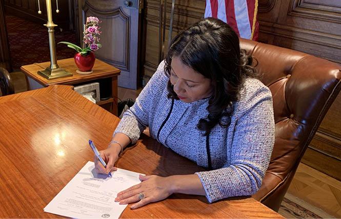 Mayor London Breed signs legislation June 25 to designate a historic LGBT eatery site in North Beach a city landmark. Photo: Courtesy of mayor's office