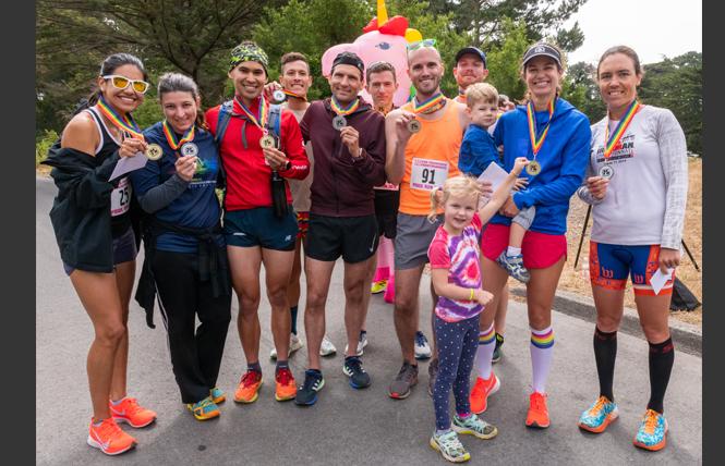 First, second, and third place winners in the 5K and 10K San Francisco Pride Run show off their medals. From left are: Lizeth Aparicio, Angela Knotts, Justin Bandoro, Christopher Kirchhoff, Nick Kovaleski, Freddie Manners, Terence Byrnes, Bryan Eckstein, Suzanne Hyer, and Zuzana Trnovcova. Photo: Jane Philomen Cleland