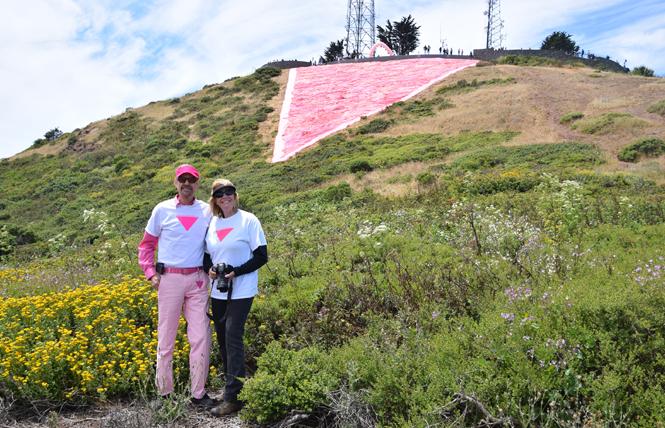 Patrick Carney, left, and his sister, Colleen Hodgkins, stand near the completed pink triangle June 29. Photo: Hossein Carney