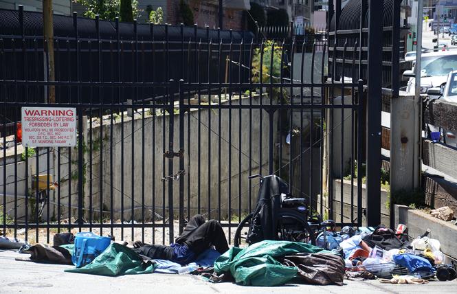 A man slept on Market Street near Collingwood Street last month. Photo: Rick Gerharter