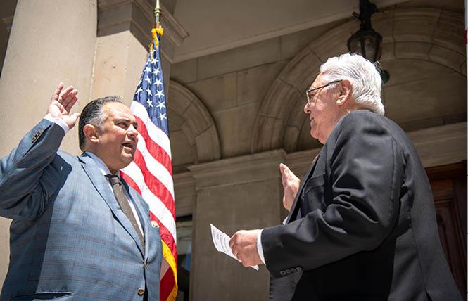 Gay former Assembly speaker John A. Pérez, left, was sworn is as chair of the UC Board of Regents July 1 by gay former state Democratic Party chairman Art Torres. Photo: Courtesy Twitter