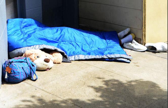 A man slept on a sidewalk in the Castro district in April 2018. Photo: Rick Gerharter