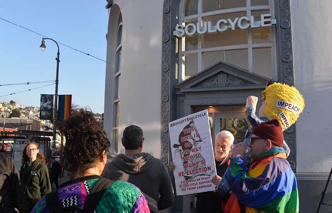 Activist Michael Petrelis, right, held an "Impeach Trump" piñata during his protest Wednesday outside SoulCycle in the Castro. Photo: Bill Wilson