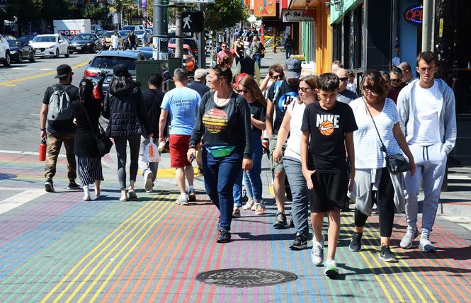 Shoppers and pedestrians cross at the intersection of Castro and 18th streets, one of the busiest in the neighborhood. Photo: Rick Gerharter