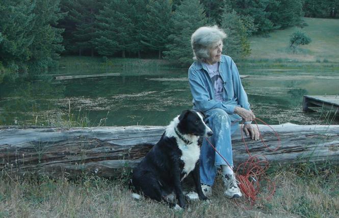 Sally Gearhart sits by a lake with her dog, Bodhi, in a scene from the film, "A Great Ride." Photo: Courtesy Deborah Craig