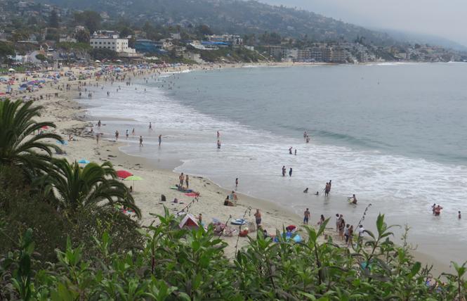 People enjoy Main Beach in Laguna Beach, as seen from cliff top Heisler Park. Photo: Charlie Wagner