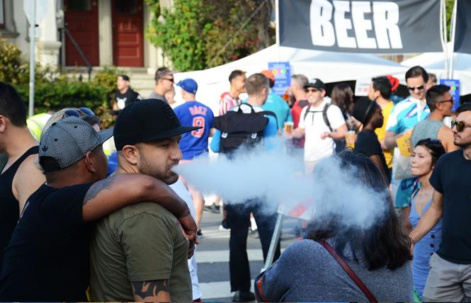 A man vapes Sunday while attending the Castro Street Fair. Photo: Rick Gerharter
