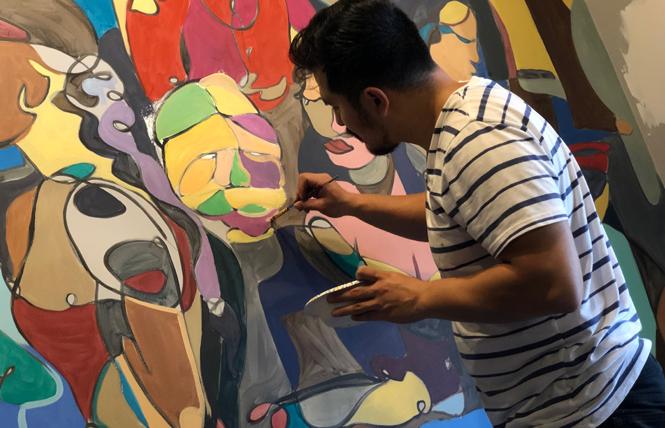 Miguel Herrera paints a mural on the wall at Bhoga Restaurant & Bar Monday, October 7. The Castro Street "progressive Indian" restaurant is slated to open in mid-November. Photo: John Ferrannini