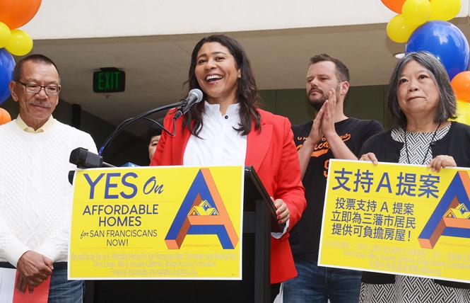 Mayor London Breed, center, joined by Supervisors Norman Yee, Matt Haney, and Sandra Lee Fewer, speaks to volunteers at the September campaign kickoff for Proposition A, a $600 million housing bond for San Francisco. Photo: Rick Gerharter