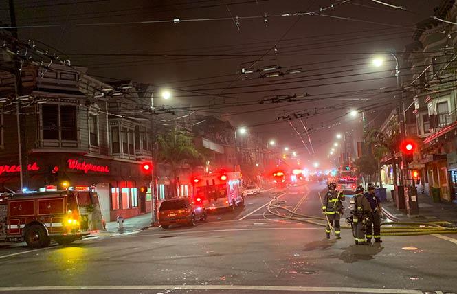 Firefighters mop up after a four-alarm fire in the Castro early Saturday morning. Photo: Michael Yamashita