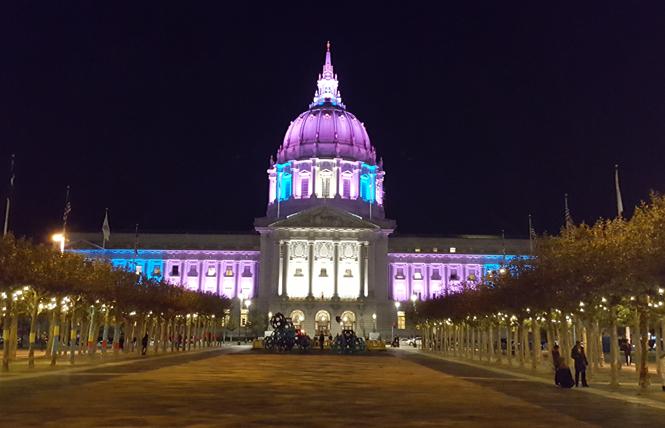 San Francisco City Hall is lit in the colors of the trans flag. Photo: Cynthia Laird