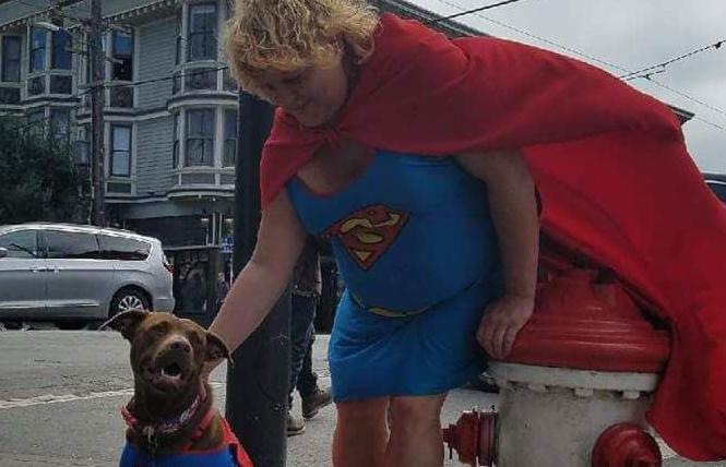 Shawn Sunshine Strickland, aka the Supergirl of San Francisco, pets a dog. Photo: Courtesy Donald Wagda