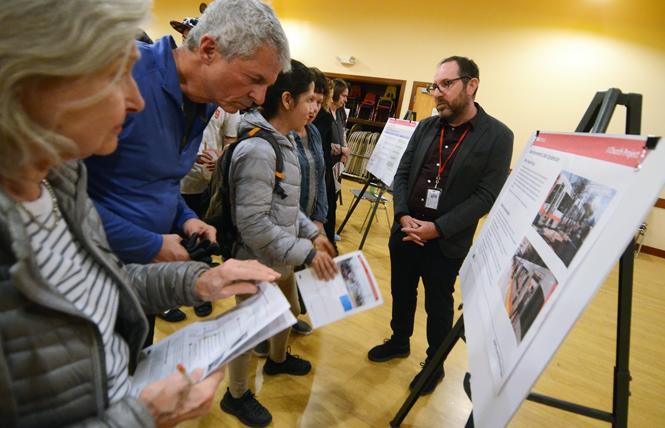 Noe Valley residents check out information on proposed changes to the J-Church Muni line at a community meeting Monday. Photo: Rick Gerharter