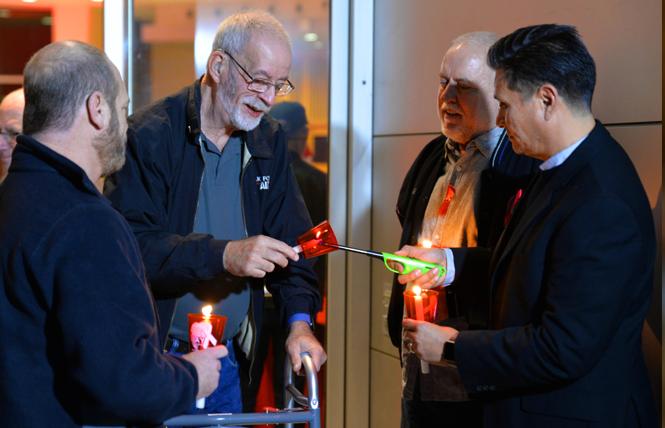 People remember those last to AIDS at a World AIDS Day observance December 3 outside San Jose City Hall. Photo: Jo-Lynn Otto