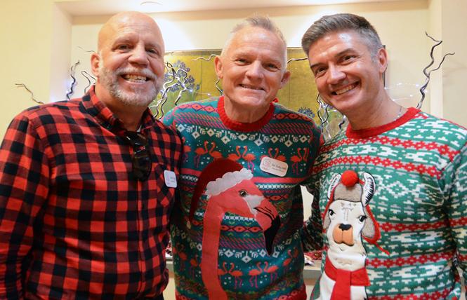Jim King, left, board president of Maitri Compassionate Care, joined Executive Director the Reverend Rusty Smith and his husband, Scott Reiber, at the hospice's annual holiday open house December 14. Photo: Rick Gerharter