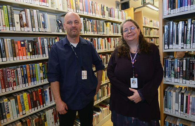 Casey Crumpacker, acting manager of the Eureka Valley/Harvey Milk Memorial Branch Library, left, and Janine deManda, adult services librarian, stand near the library books. Photo: Rick Gerharter