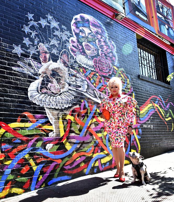 Juanita MORE! with her dog Jackson and a colorful Serge Gay, Jr. mural, one of several commissioned at venues around San Francisco. photo: Gooch