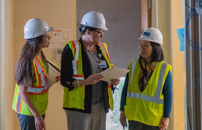 Department of Public Health officials Maricella Miranda, left; Kathy Jung; and Dr. Hali Hammer check out the work at the under-renovation Maxine Hall Health Center in the Western Addition. Photo: Jane Philomen Cleland