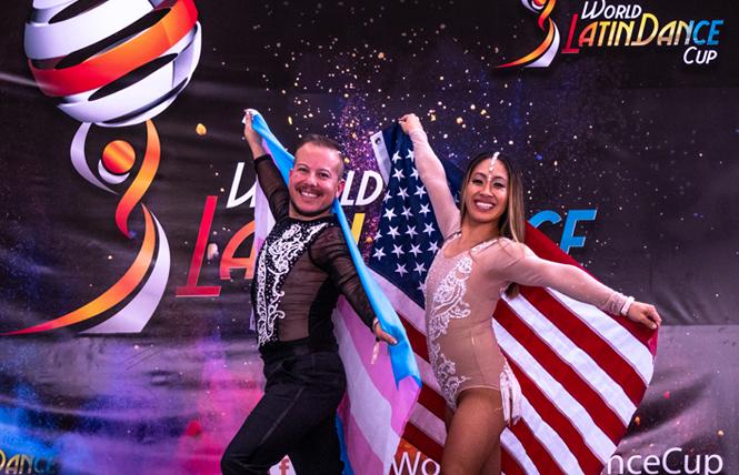 Luis Gutierrez-Mock, left, holding the trans pride flag, and Ngoc Huynh, won the amateur bachata cabaret division at the World Latin Dance Cup in Medellin, Colombia in December. Photo: Takeshi Young/World Latin Dance Cup
