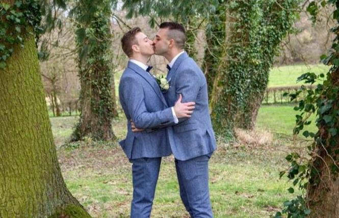 Matthew Mitcham, left, kissed his husband, Luke Rutherford, during the couple's public ceremony in Belgium. Photo: Courtesy Instagram