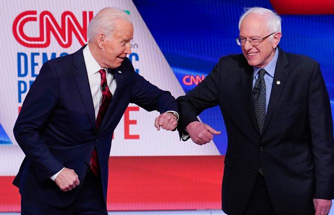 Former Vice President Joseph R. Biden Jr. and Senator Bernie Sanders of Vermont practiced social distancing by greeting each other with elbow bumps at Sunday's debate. Photo: Courtesy AP