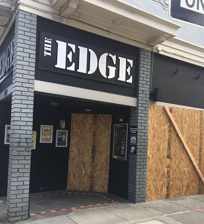 The staff of The Edge, one of all bars closed, also boarded up the bar's windows to prevent looting. photo: Mark Abramson