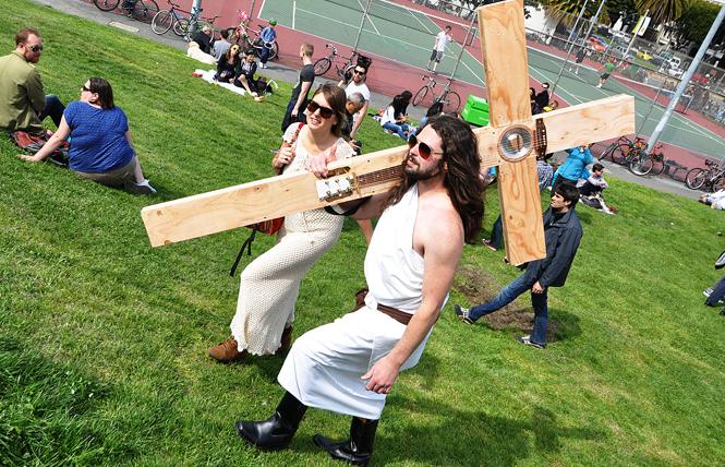 "Funky Jesus" Sean Lavelle, right, with his custom designed wooden cross, won the 2012 Hunky Jesus contest at the annual Easter Celebration in Dolores Park hosted by the Sisters of Perpetual Indulgence. Lavelle crafted a functioning guitar onto a wooden cross, playing a few riffs in his winning bid. Photo: Rick Gerharter