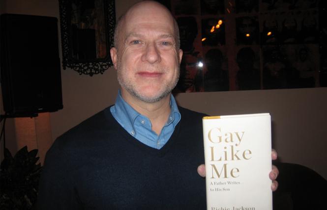 Richie Jackson holds a copy of his memoir, "Gay Like Me: A Father Writes to His Son," at his February event at Manny's in San Francisco. Photo: Brian Bromberger