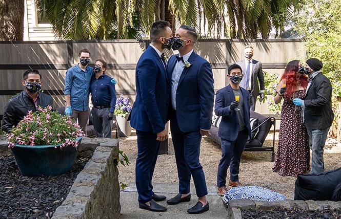 César Salza, left, and Kyle Hill tied the knot at a friend's home April 18, complete with physical distancing. Photo: Kauhi Hookano