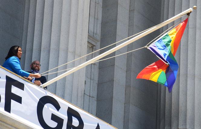Mayor London Breed and District 8 Supervisor Rafael Mandelman raise the rainbow flag at City Hall Wednesday, June 3, to commemorate June as being LGBTQ Pride month. Photo: Rick Gerharter