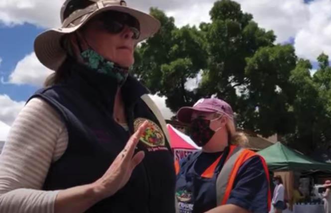 In a screenshot from a video taken June 7, California Farmers' Markets Association director Gail Hayden objects to a vendor passing out Pride flags. Photo: Courtesy Livermore Pride