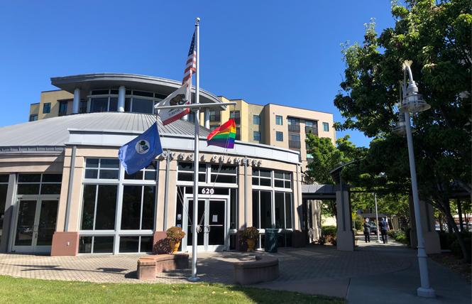 Foster City staff borrowed the rainbow flag from Island United UCC Church and raised it Tuesday in front of City Hall. Photo: Courtesy Foster City